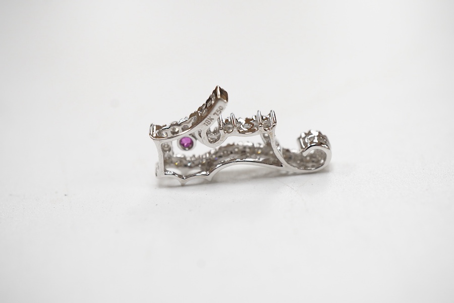 A recent 18k white metal diamond cluster set seahorse charm/pendant, with single stone ruby set eye, 19mm.